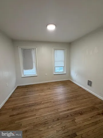 wooden floor in an empty room with window