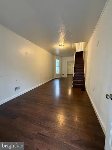 an empty room with wooden floor