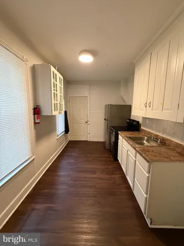 a kitchen with granite countertop a stove and a refrigerator