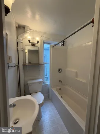 a bathroom with a toilet bathtub and shower