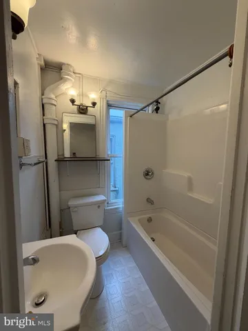 a bathroom with a toilet bathtub and shower