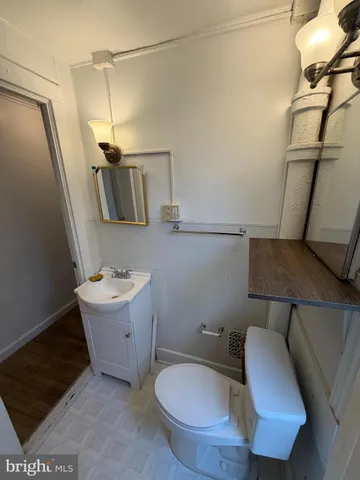 a bathroom with a toilet and a mirror