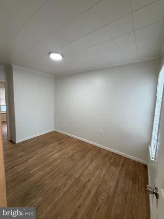 a view of an empty room and wooden floor