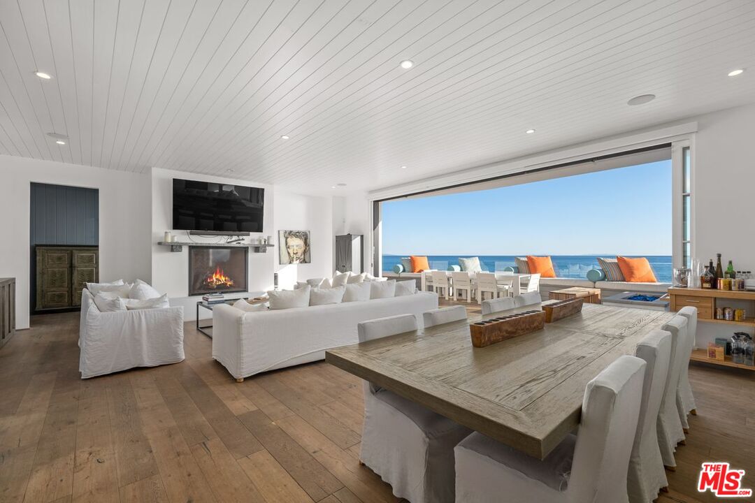 27212 Escondido Beach Road Malibu, CA 90265 - Photo 5 of 35 a living room with fireplace furniture and a flat screen tv