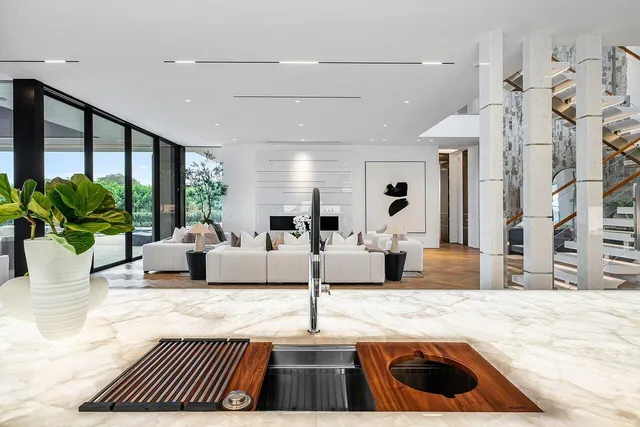 a living room with fireplace furniture and a large window