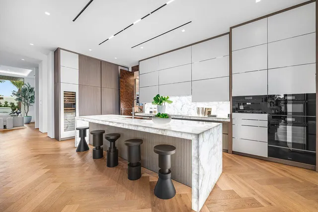 a living room with furniture fireplace and a large window