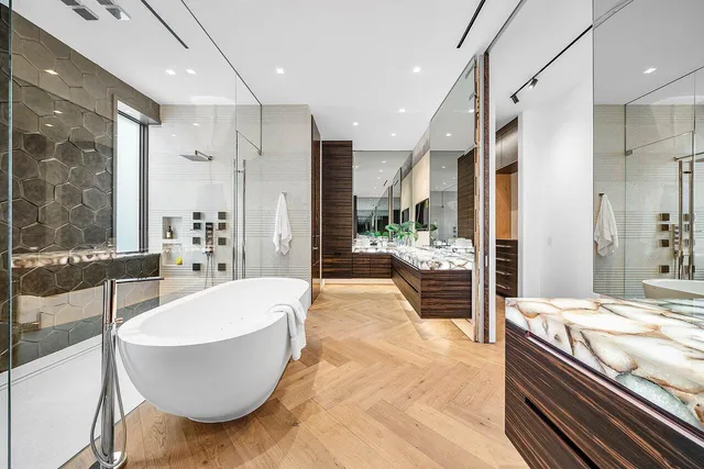 a spacious bedroom with a bed and a potted plant