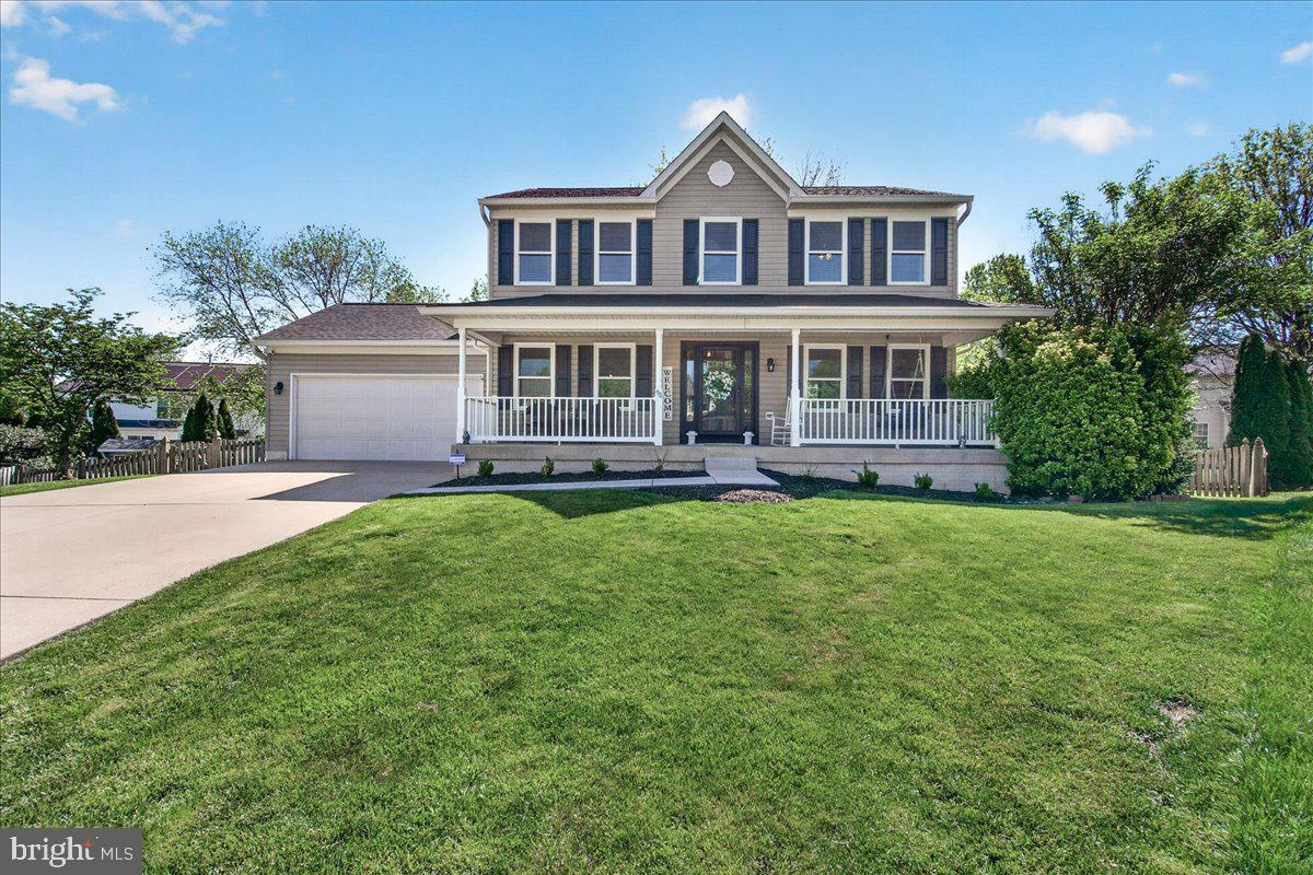 98 Pleasanton Court Frederick, MD 21702 - Photo 1 of 62 a front view of a house with a yard and trees