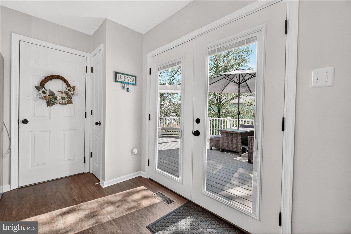 98 Pleasanton Court Frederick, MD 21702 - Photo 14 of 62 a view of an entryway with wooden floor and a livingroom view