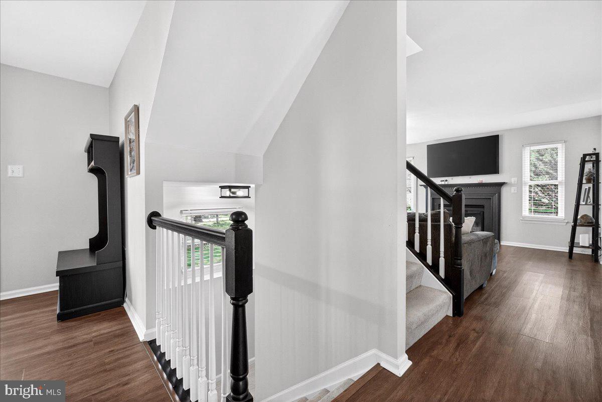 98 Pleasanton Court Frederick, MD 21702 - Photo 17 of 62 a view of a hallway with wooden floor and staircase