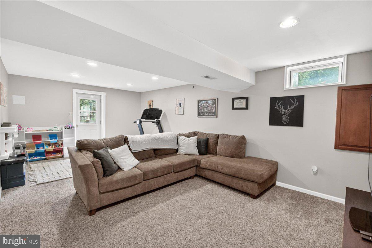 98 Pleasanton Court Frederick, MD 21702 - Photo 24 of 62 a living room with furniture and a flat screen tv