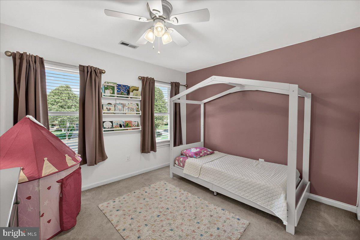 98 Pleasanton Court Frederick, MD 21702 - Photo 29 of 62 a bedroom with a large bed and a chandelier