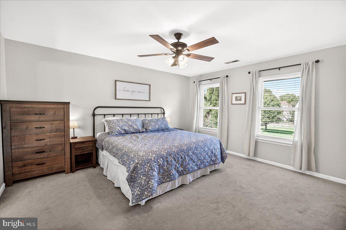 98 Pleasanton Court Frederick, MD 21702 - Photo 32 of 62 a spacious bedroom with a bed and a ceiling fan