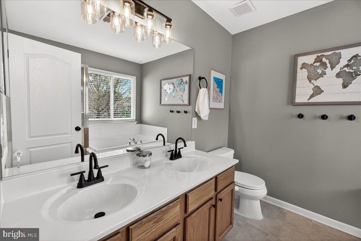 98 Pleasanton Court Frederick, MD 21702 - Photo 34 of 62 a bathroom with a sink mirror and toilet