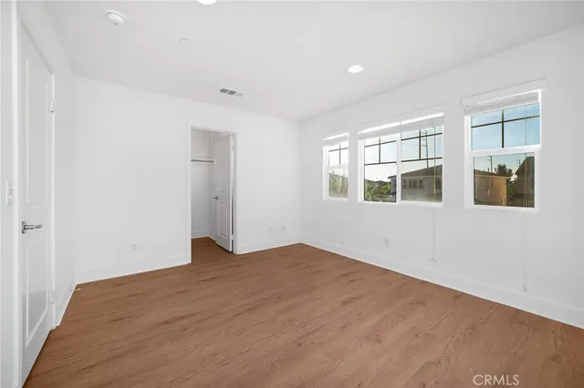 a spacious bathroom with a double vanity sink mirror and bathtub