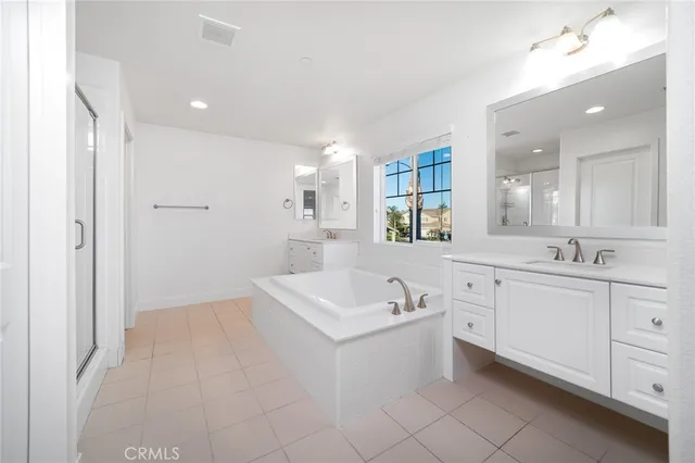 a bathroom with a bathtub shower and a sink