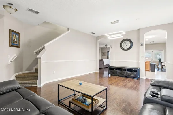 a living room with furniture and a clock