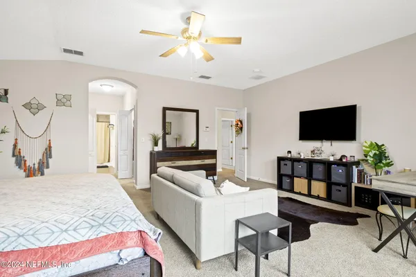 a bedroom with furniture and a flat screen tv