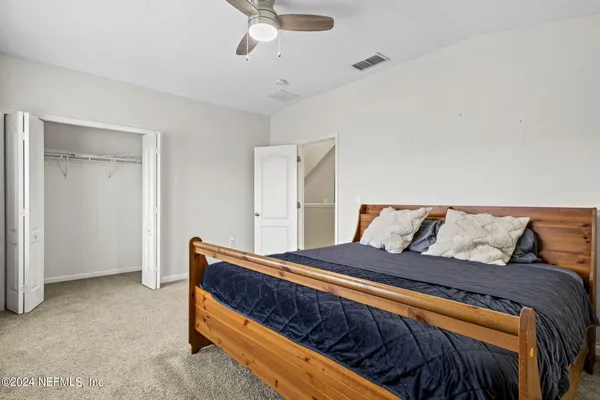 a bedroom with bed and window