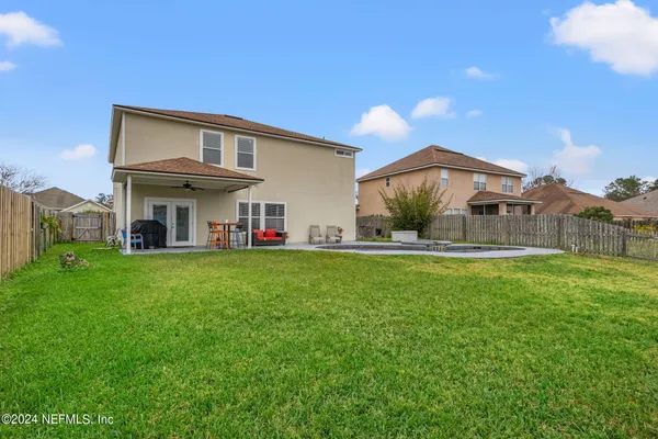 a view of a house with backyard and sitting area