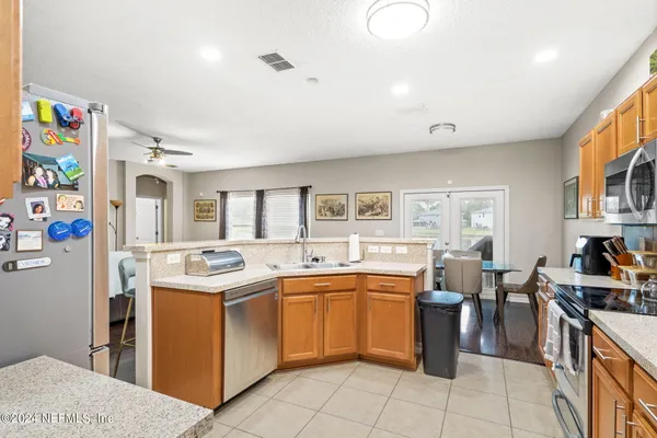 a kitchen that has a sink and a stove in it