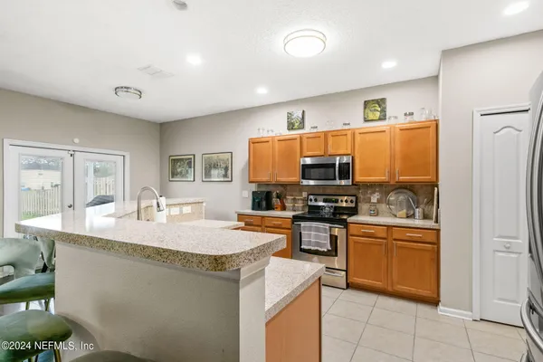 a kitchen with stainless steel appliances granite countertop a sink and stove