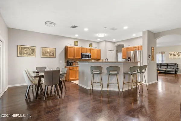 a view of a dining room with furniture and wooden floor