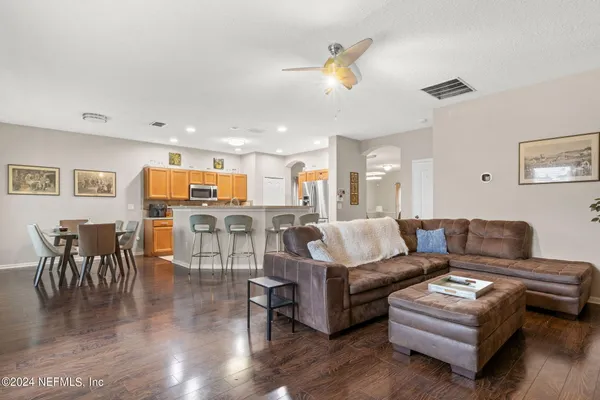 a living room with furniture and kitchen view