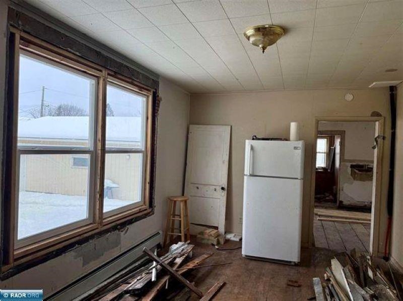 922 South 5th Avenue Virginia, MN 55792 - Photo 2 of 12 Kitchen featuring baseboard heating and freestanding refrigerator