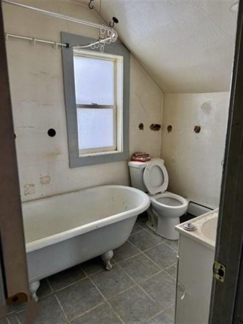 922 South 5th Avenue Virginia, MN 55792 - Photo 6 of 12 Bathroom with vanity, vaulted ceiling, and light tile patterned floors