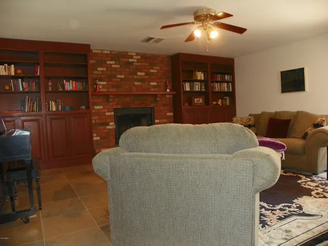 a living room with furniture a lamp and a fireplace