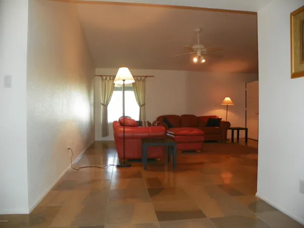 a living room with furniture a lamp and a potted plant