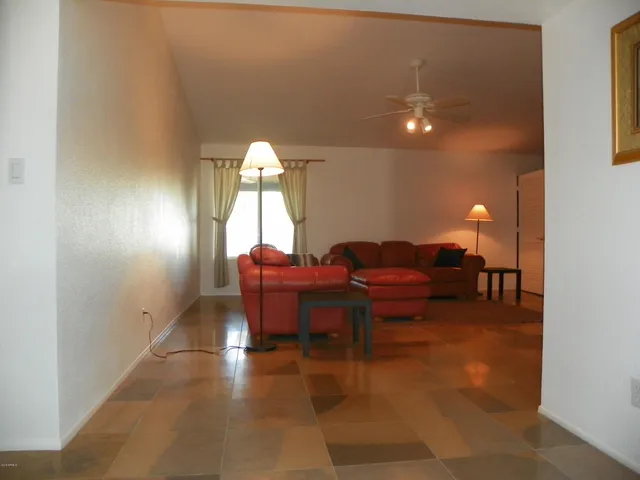 a living room with furniture a lamp and a potted plant