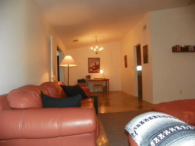 a large bedroom with a bed and wooden floor