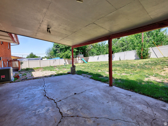 1272 Cook Street Ogden, UT 84404 - Photo 6 of 46 Covered concrete patio extending to a fenced backyard with green space