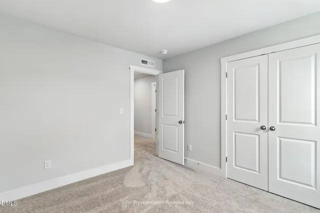 an empty room with an entrance to other room