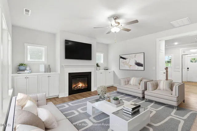 a kitchen with a stove a sink a stove a refrigerator and white cabinets with wooden floor