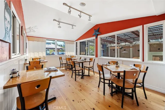 a view of a dining room with furniture and window