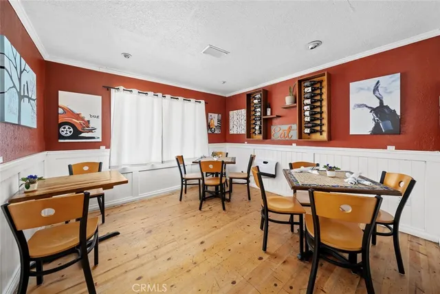 a outdoor dining space with furniture and wooden floor