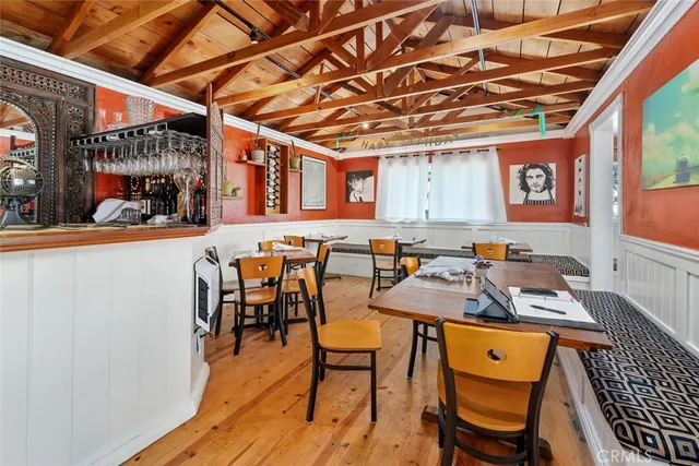 a outdoor dining space with furniture and wooden floor