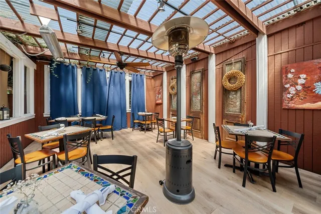 a view of backyard with table and chairs and potted plants