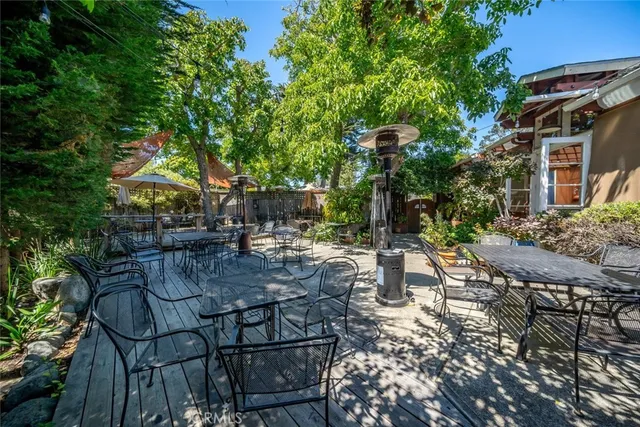 a kitchen with stainless steel appliances granite countertop a stove top oven a sink dishwasher and cabinets with wooden floor