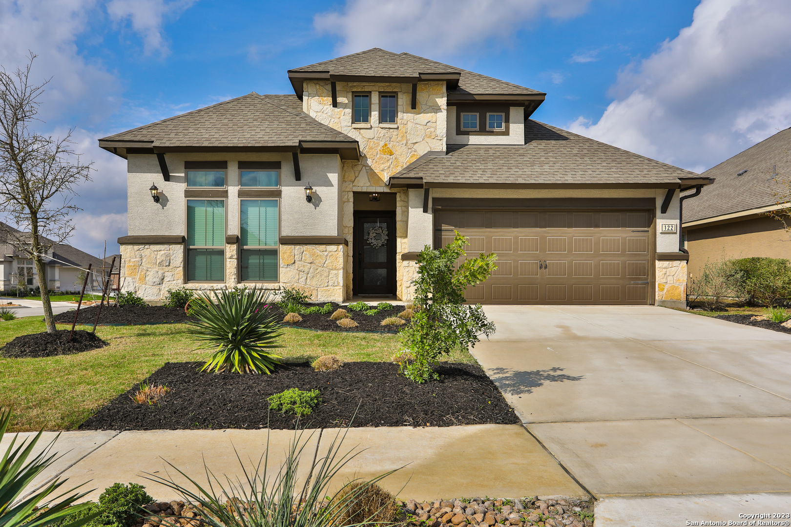 a front view of a house with garden