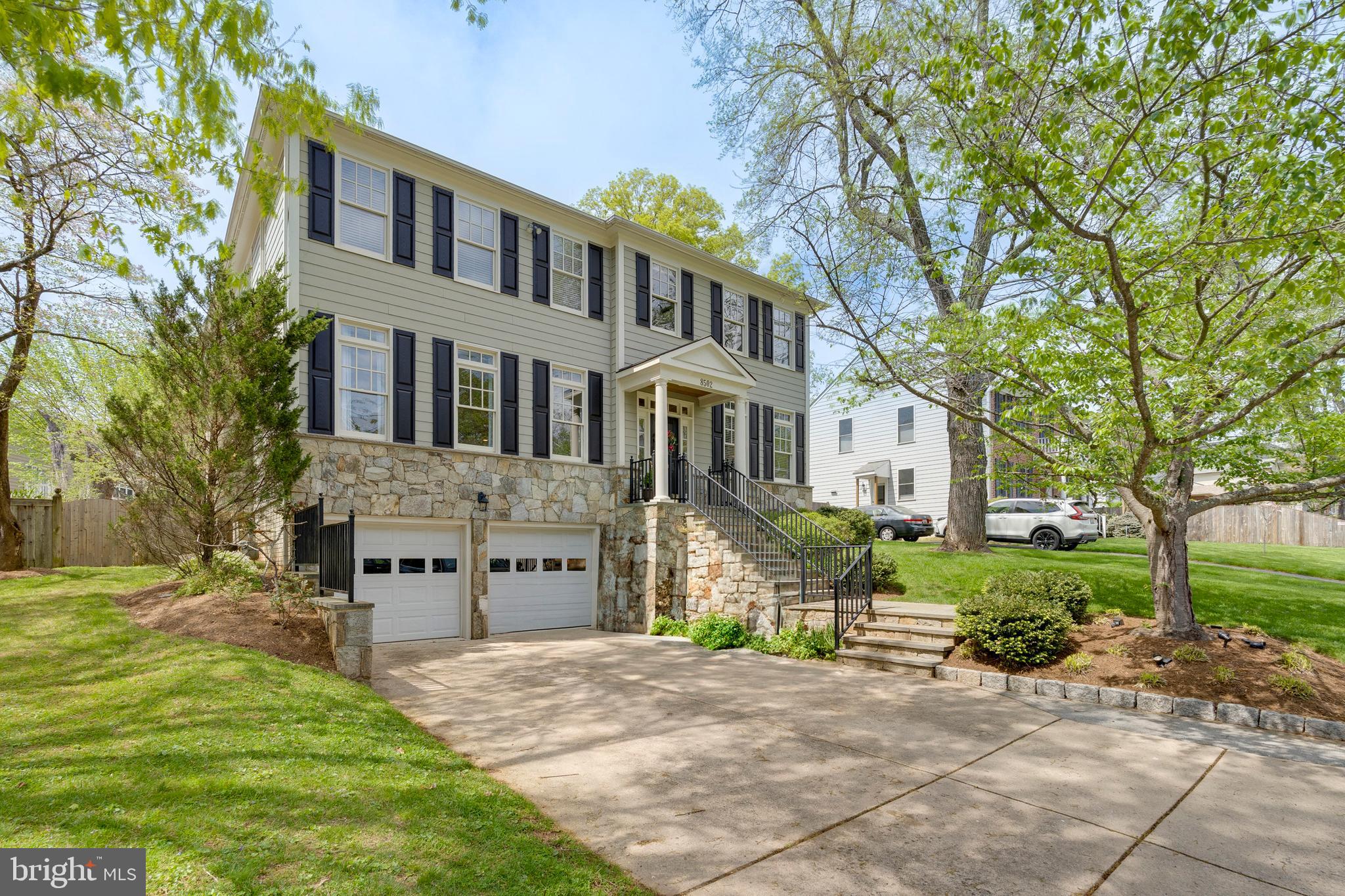 8502 Rayburn Road Bethesda, MD 20817 - Photo 1 of 49 a front view of a house with a yard and garage