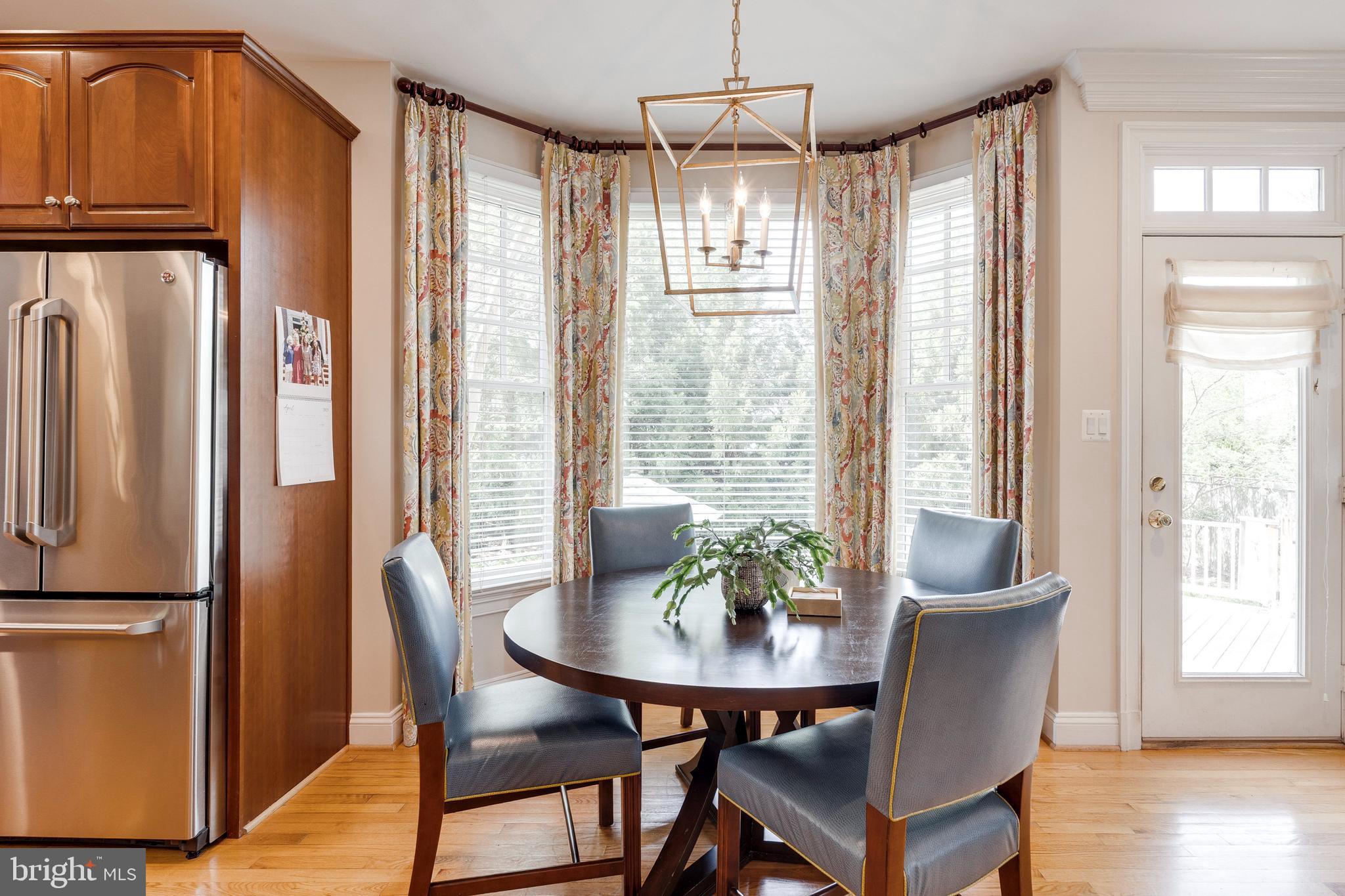 8502 Rayburn Road Bethesda, MD 20817 - Photo 13 of 49 a view of a dining room with furniture window and wooden floor