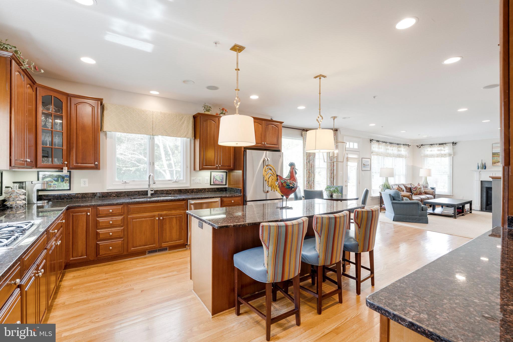 8502 Rayburn Road Bethesda, MD 20817 - Photo 14 of 49 a kitchen with stainless steel appliances granite countertop wooden floor dining table and chairs