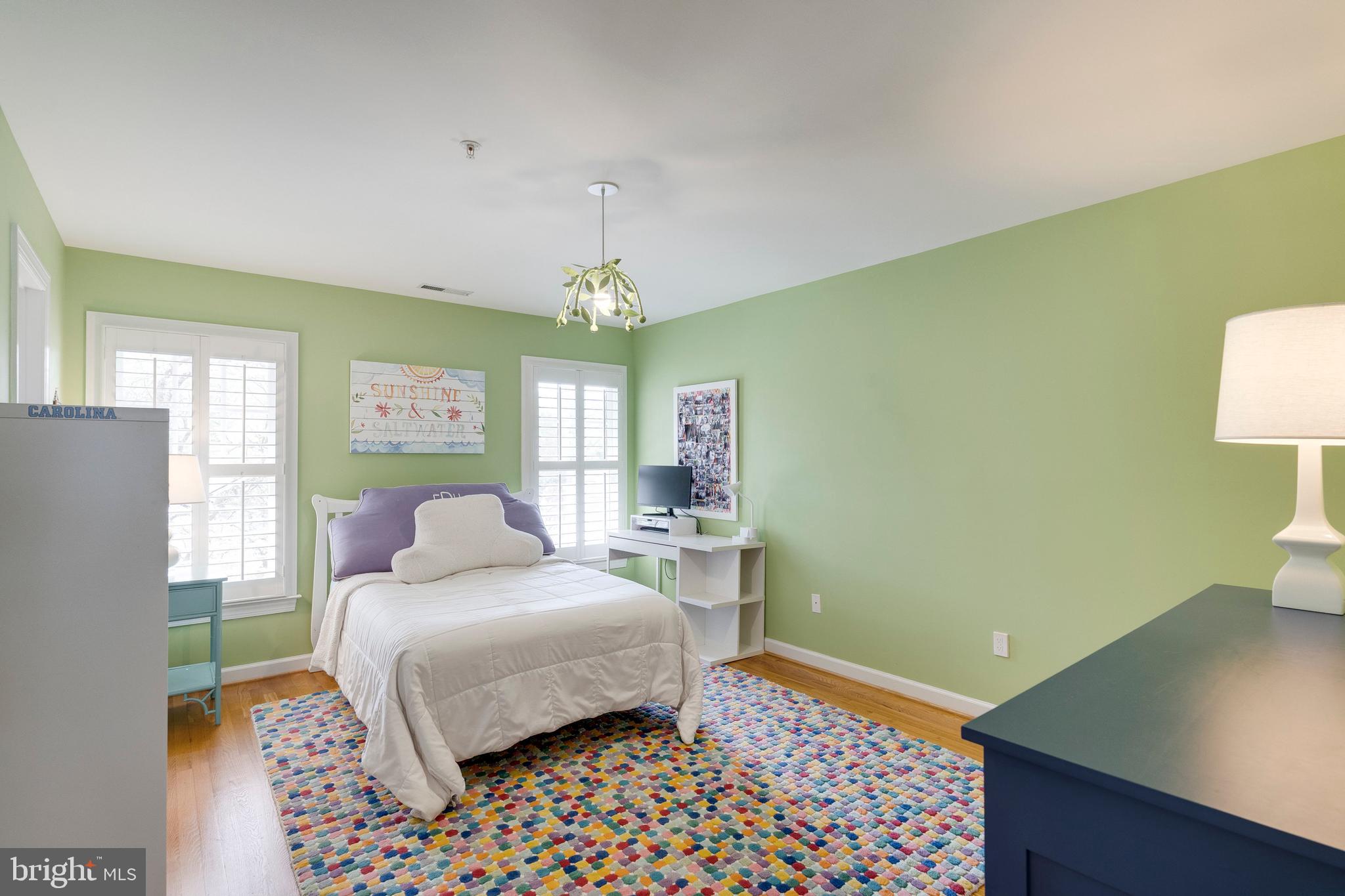 8502 Rayburn Road Bethesda, MD 20817 - Photo 30 of 49 a bedroom with a bed and a chandelier