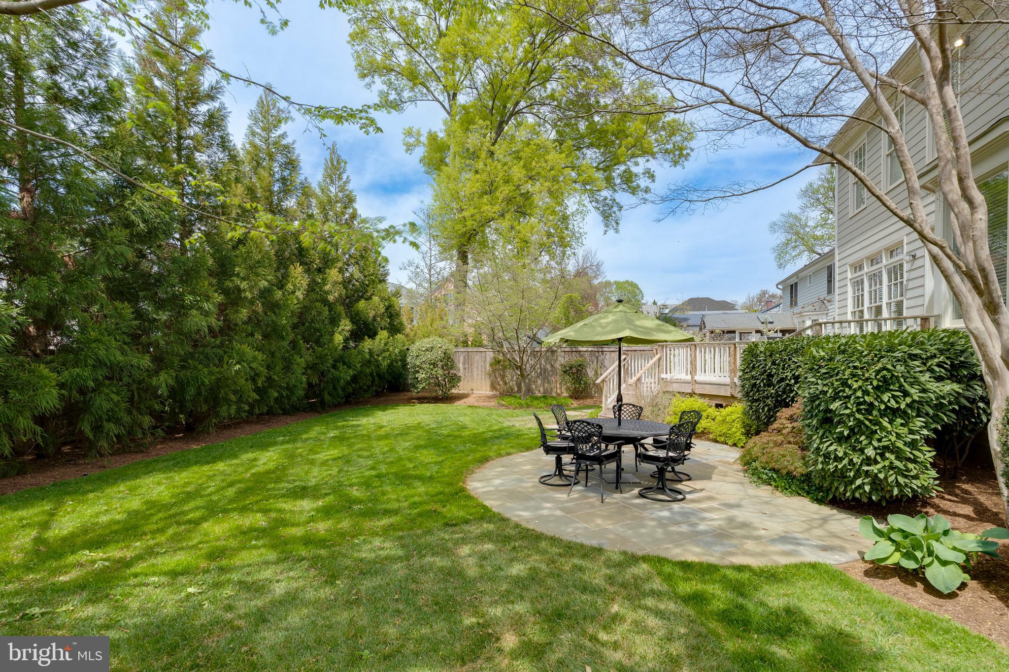 8502 Rayburn Road Bethesda, MD 20817 - Photo 45 of 49 a view of a patio with table and chairs potted plants and large tree