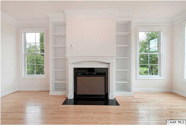 2128 Avinity Loop Charlottesville, VA 22902 - Photo 5 of 28 an empty room with wooden floor a fireplace and windows