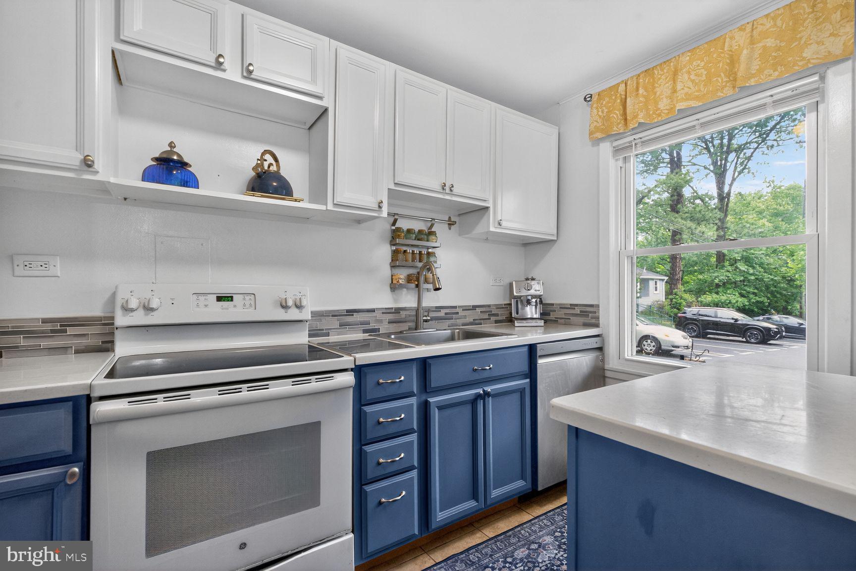 51 Ridge Road Greenbelt, MD 20770 - Photo 1 of 23 a kitchen with cabinets appliances and a window